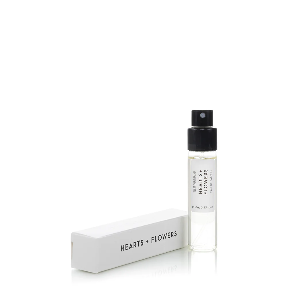 A small perfume sample vial with its cap and branded box.