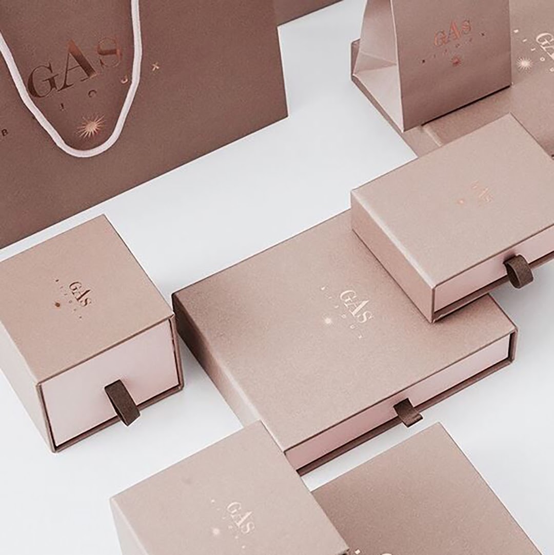 Elegant beige jewelry boxes with subtle star designs.