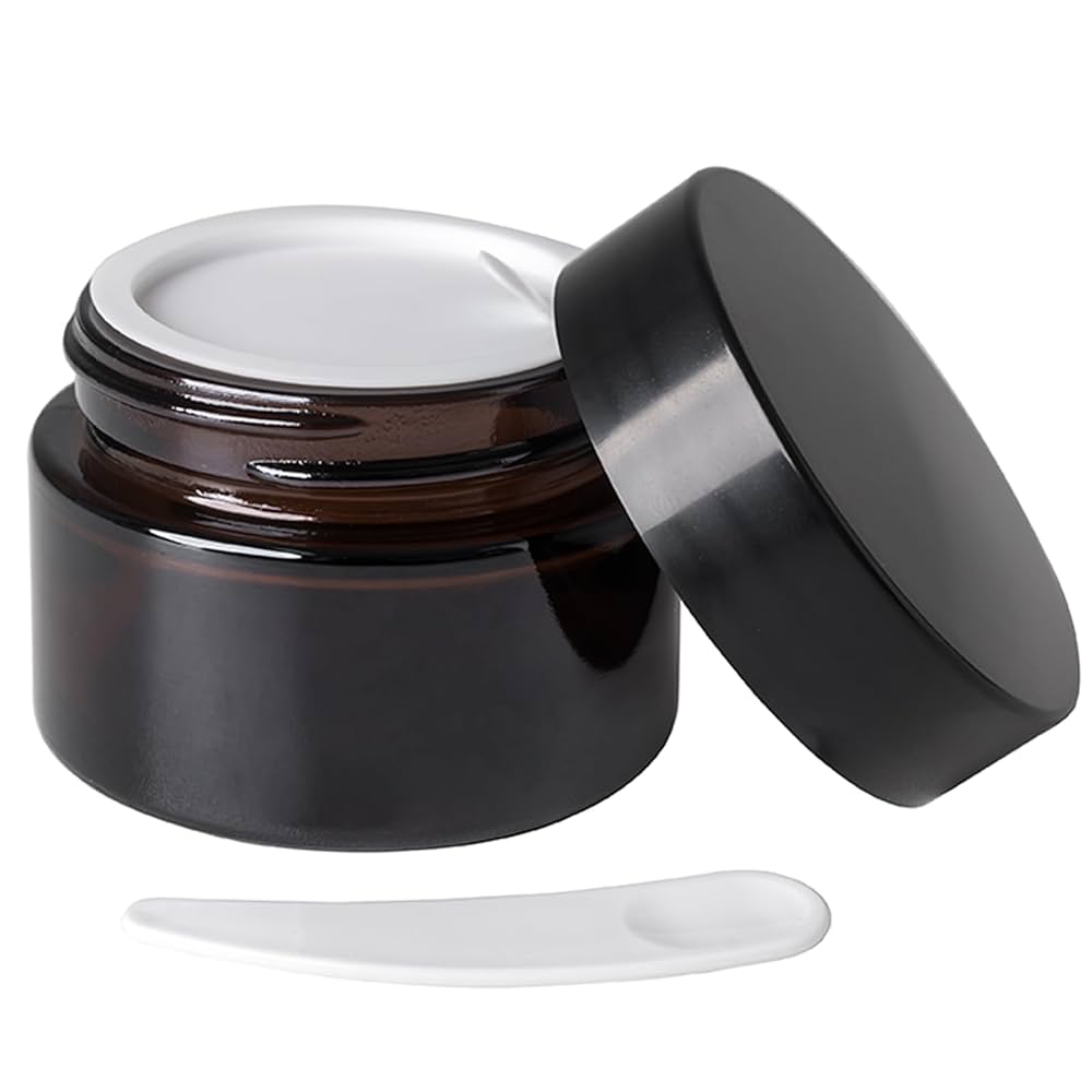 Open cosmetic jar with spatula.