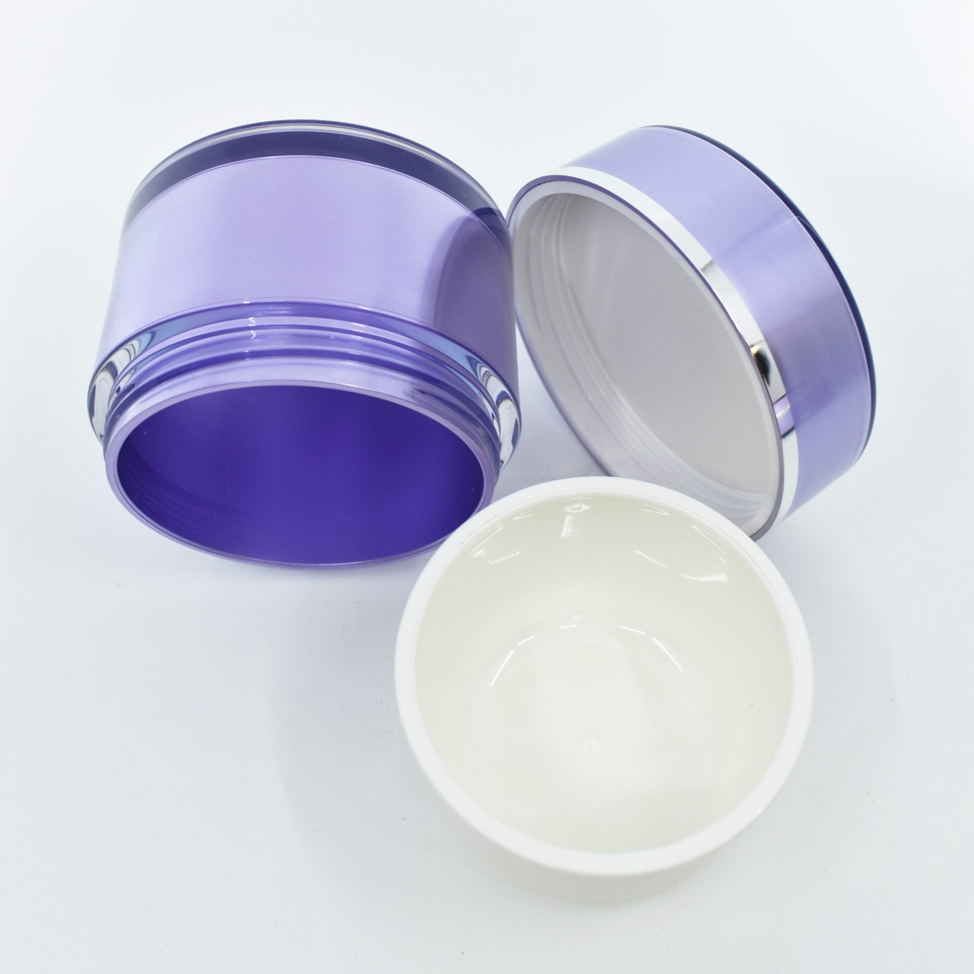 Purple and white cosmetic jars on display.