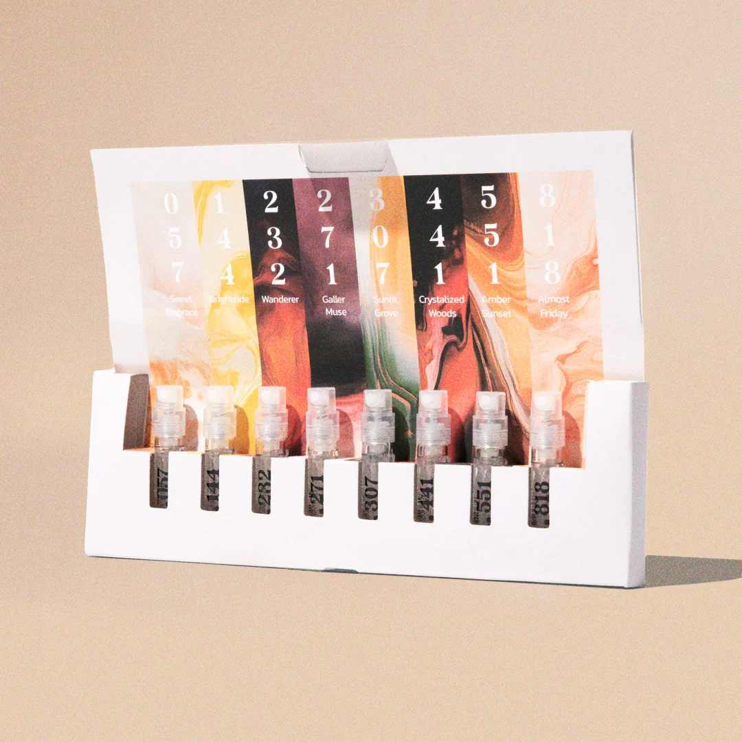 Set of seven assorted colorful lip gloss tubes in a white display box.