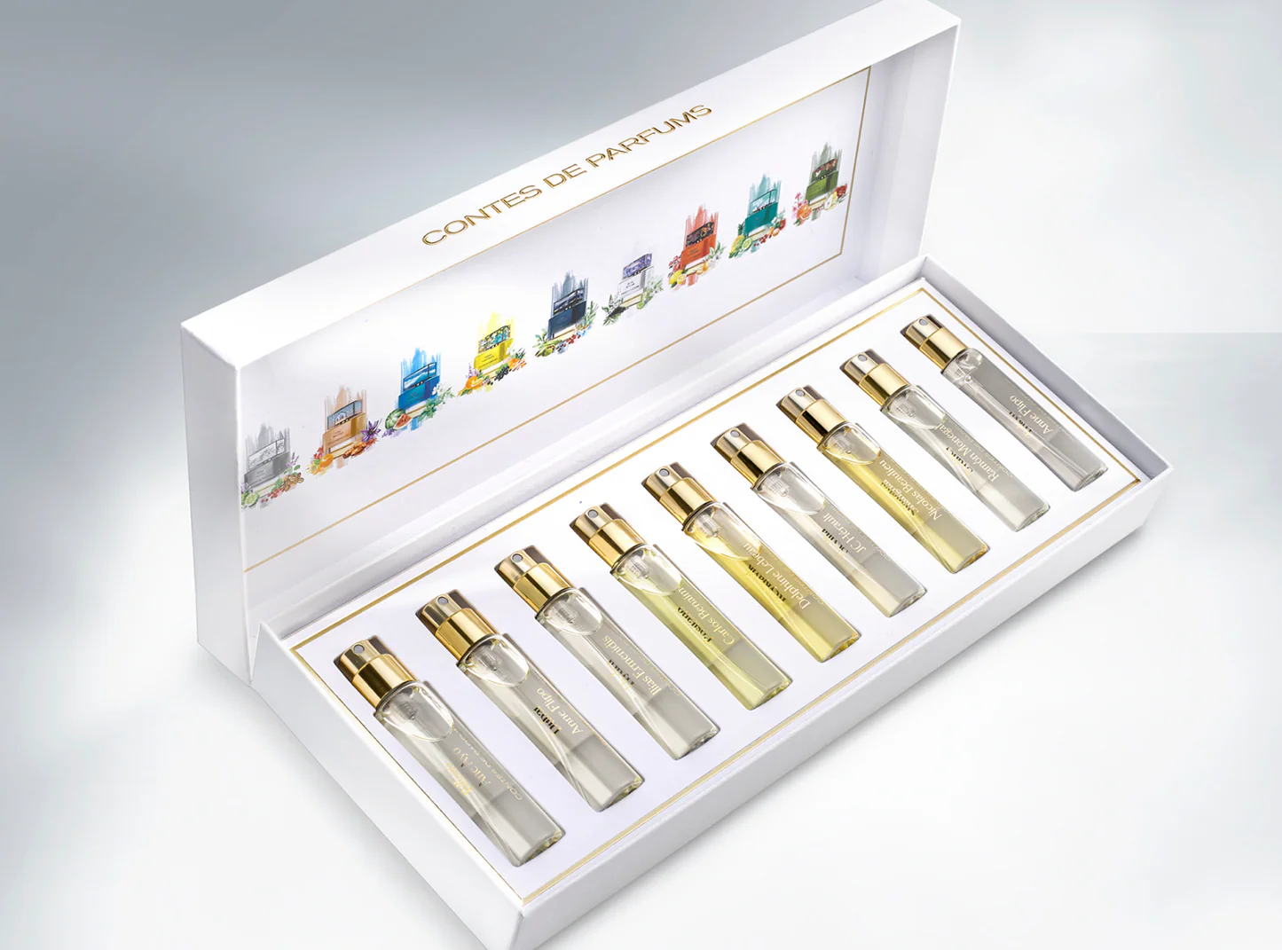Set of eight perfume samples with a white display box and gold caps.