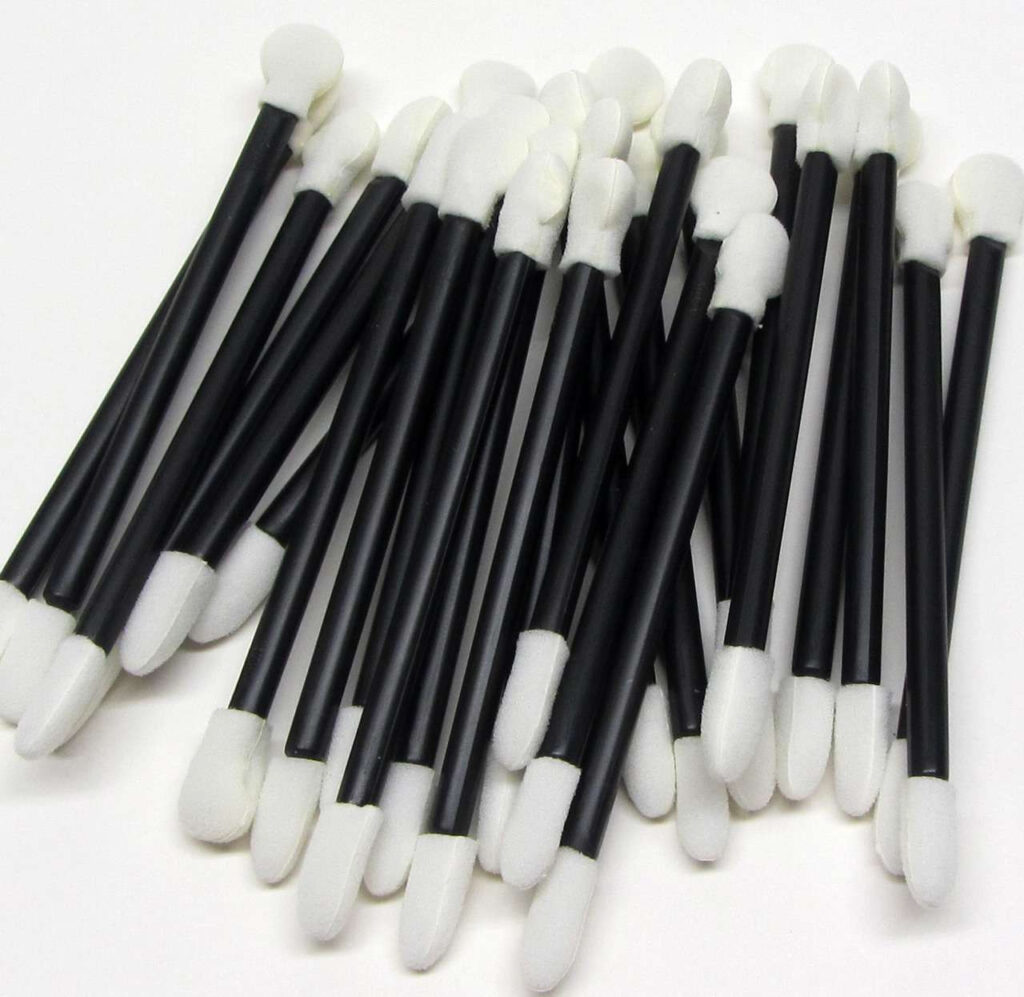 Black makeup applicators with white sponge tips.