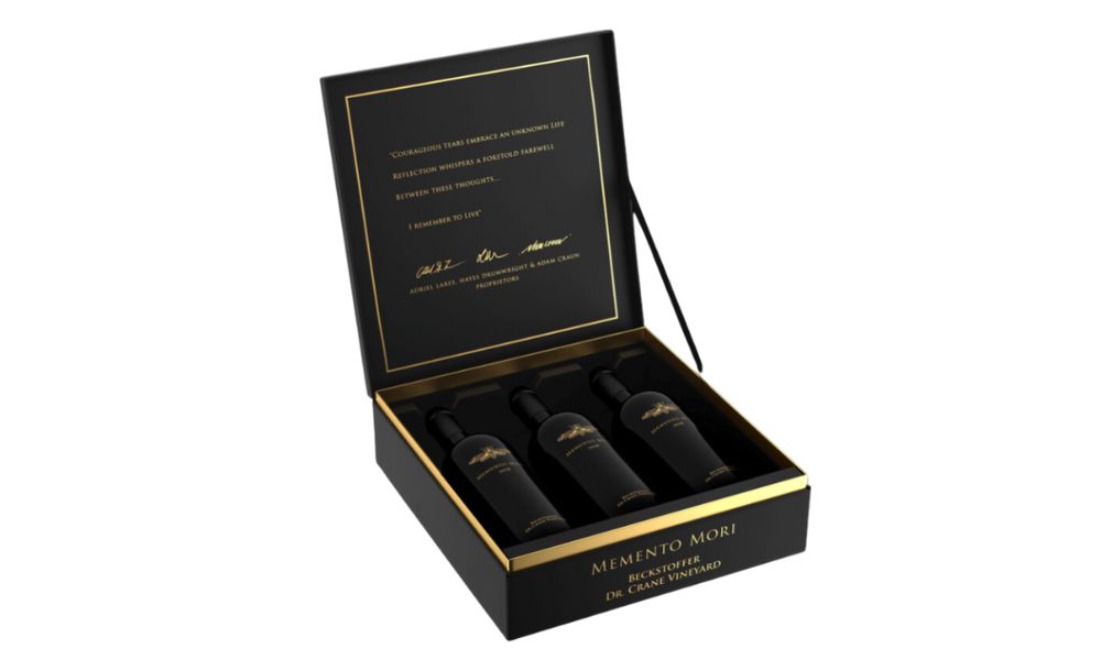 Elegant black box containing three premium wine bottles with gold lettering.
