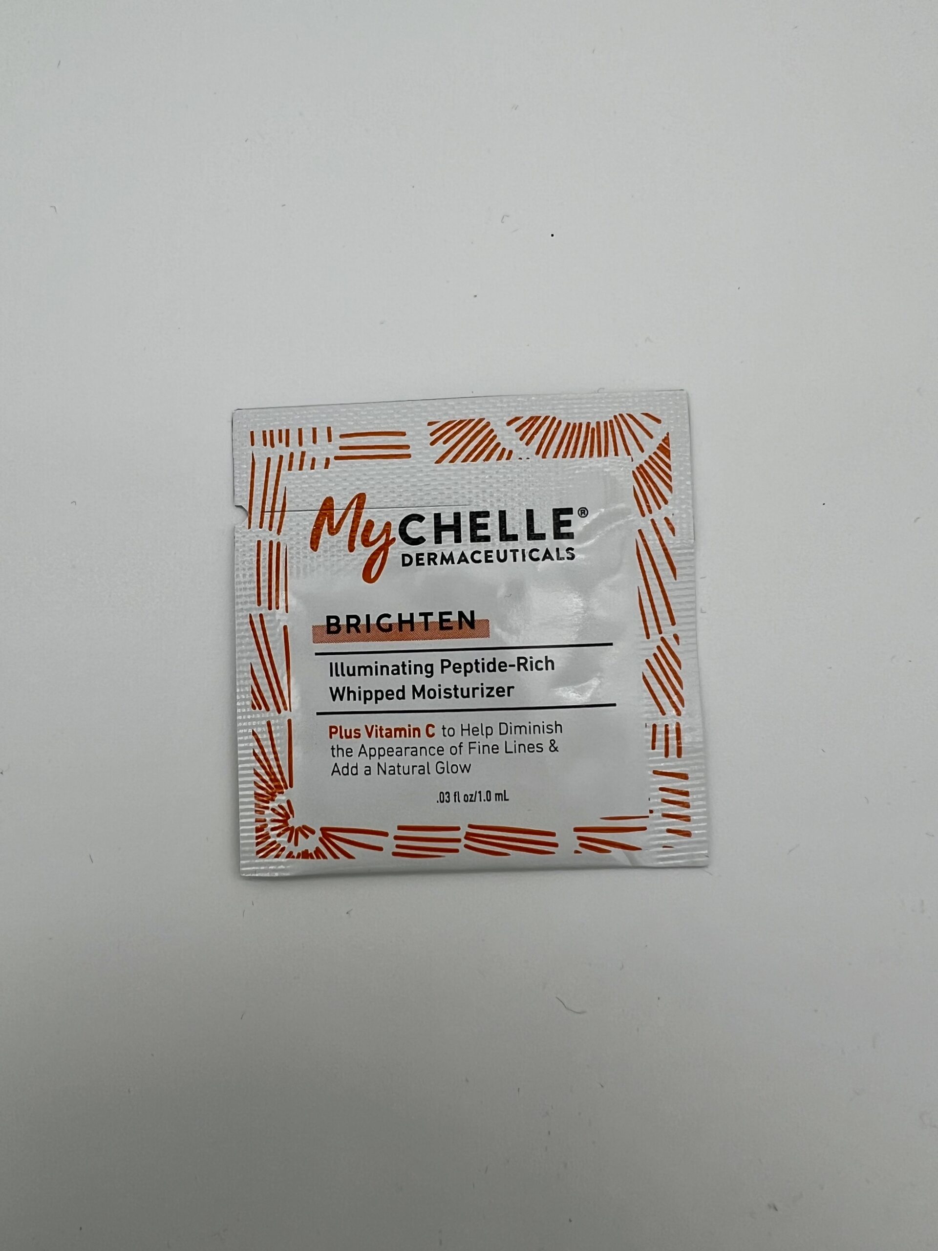 A sachet of Mychelle face wash with red and black text on a white packet.
