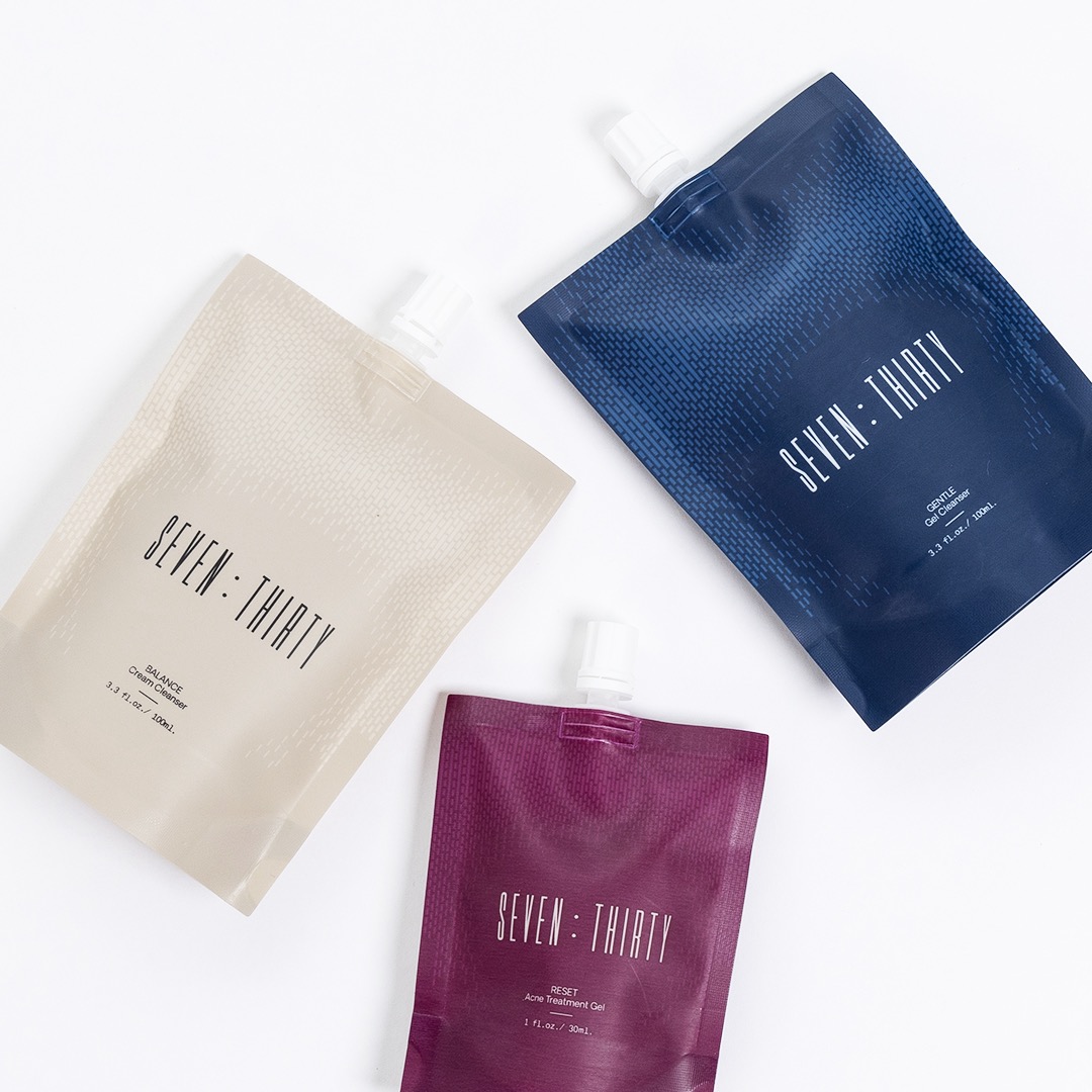 Three stylish pouches in cream, navy, and burgundy with elegant text design.