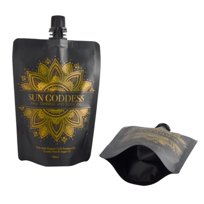 Two black and gold flexible pouch containers, one upright and one lying down.