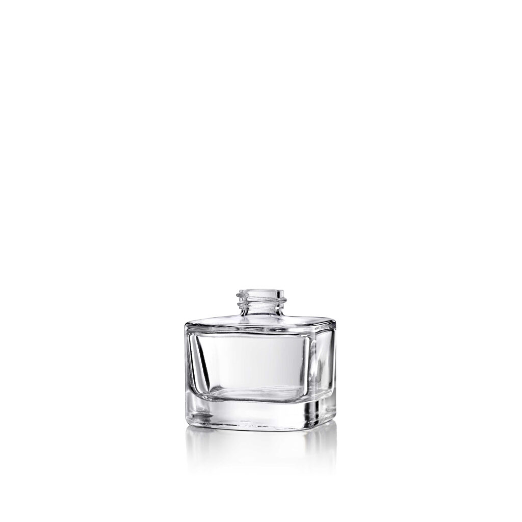A small, clear glass bottle with a wide base and narrow neck on a white background.