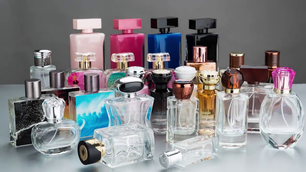 A collection of various perfume bottles arranged closely together.